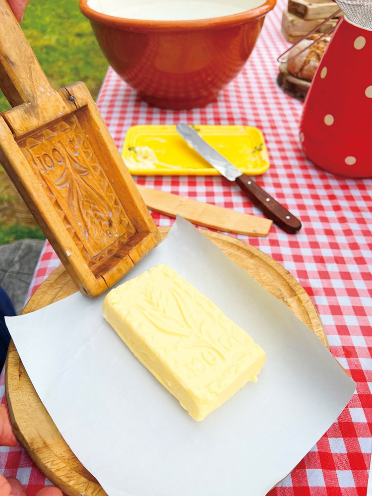 アルプミュージアムで、むかしながらのバター作りを体験。なかなか力が必要な作業だ。