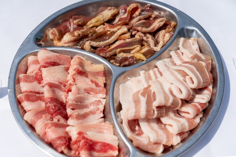 肉3種盛合わせ。上から時計回りに味付けラムスライス、脂もおいしい豚バラ肉、そしてアンガス牛カルビ。タレはBBQとジンジャーの2種類が用意されている。