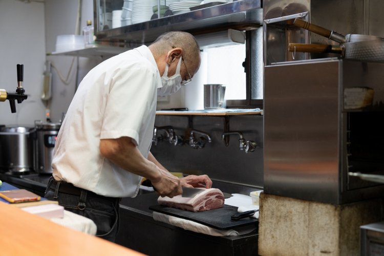 旨味がつまった肉を厚めに切っていく金村さん。ボリューム満点。