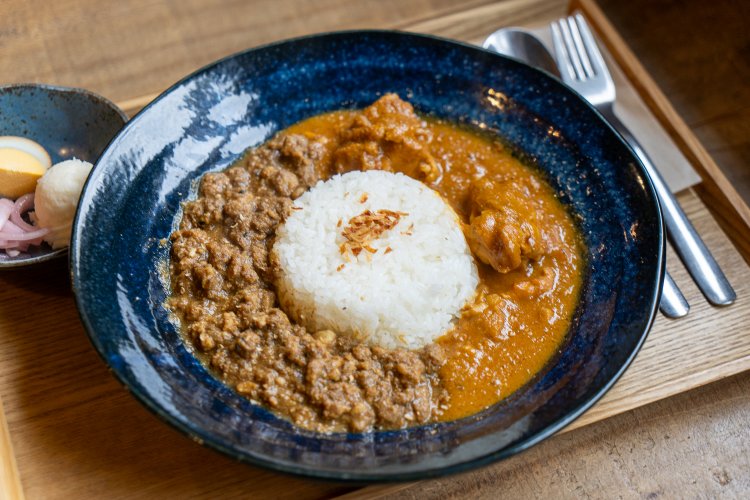 カレー2種あいがけ1200円。玉ねぎのアチャールと味付き卵、マッシュポテト付き。玉ねぎのアチャールのスパイスも絶品。