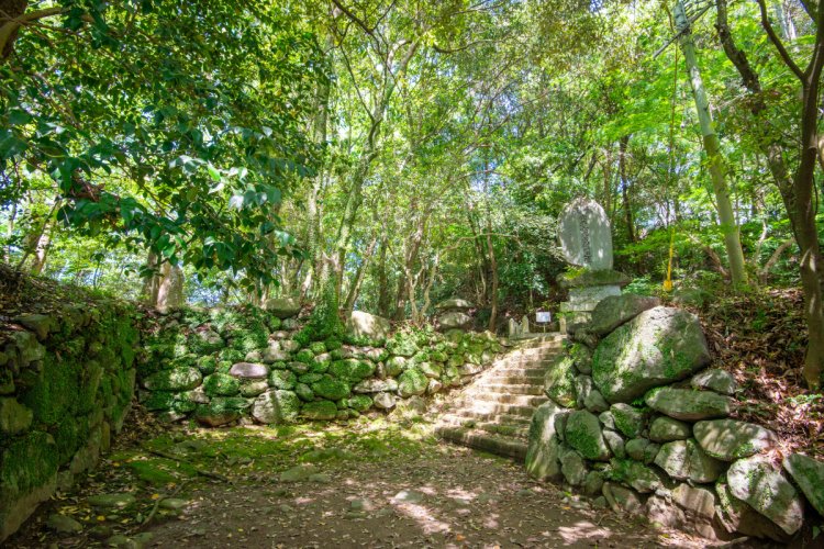 日隈城大手門跡に石垣が現存。石段を上ると日隈神社がある。