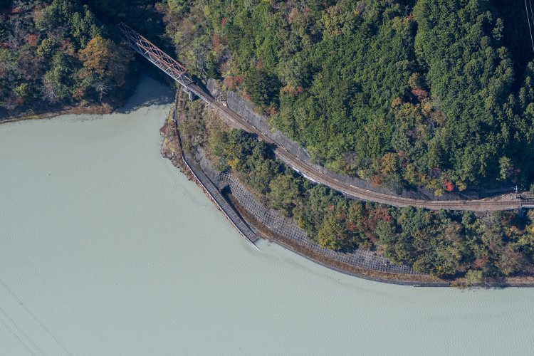 旧線の路盤が辛うじて湖面から出ている。長島ダム建設用の仮設道路が残り、第二犬間トンネルが口を開けていた。