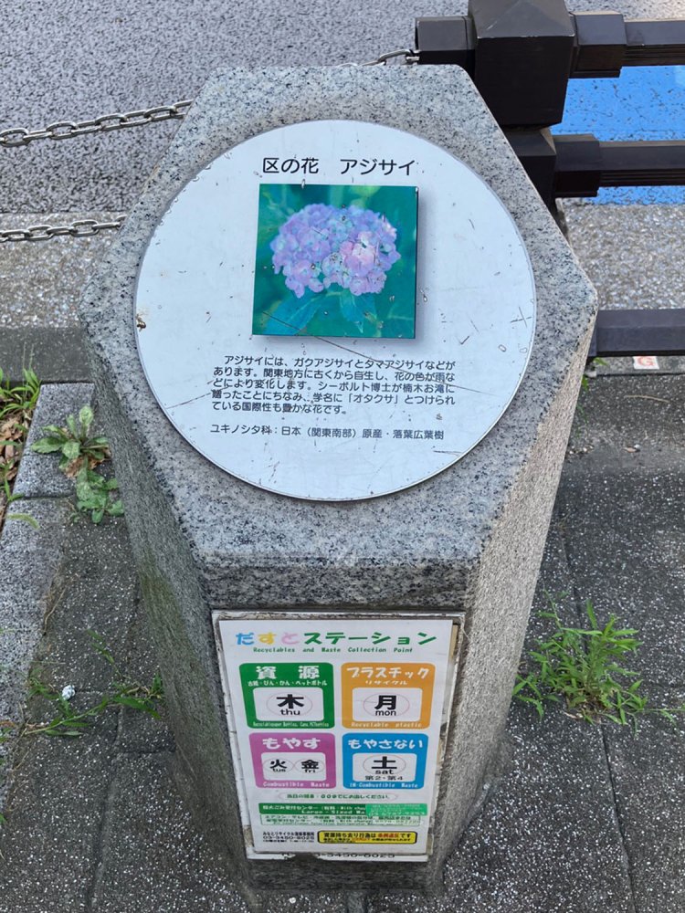 浜松町駅近くに設置された港区の花・アジサイの石柱。ごみ集積所の役割も果たしており、情報量が多い。