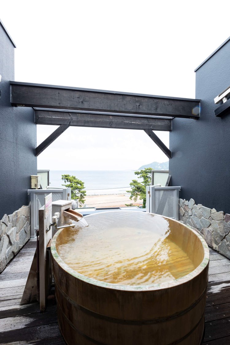 高野槙造りの貸切露天風呂「海」。相模湾の彼方に初島も見える。
