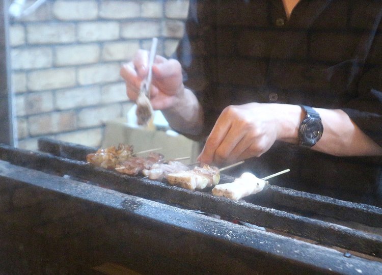 煙がお客さんの方へいかないよう、炭火の前にアクリル板を立てる配慮も。