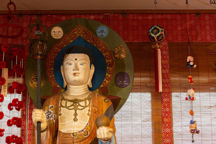 猫地蔵堂の観音像。光背に注目すると、猫の顔が描かれているのが分かる。