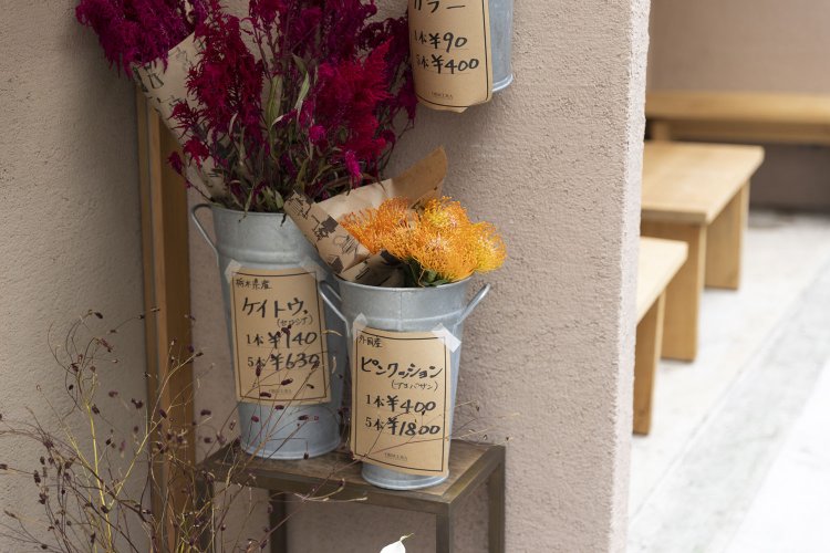 入り口脇にはおしゃれな花も。日々の生活に彩りを与えてくれる店。