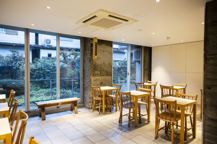 店の奥に進むとゆったりとしたテーブル席もある。大きな窓からは緑が清々しい中庭を望む。