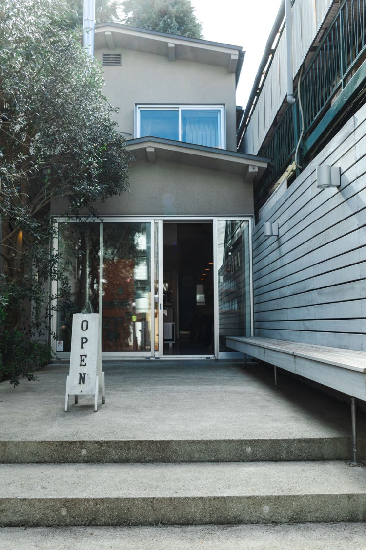 建物1階からまっすぐのびる煙突は「クリーンに焼けるように」。2階は住居。晴れた日はベンチで寛ぐのもいい。