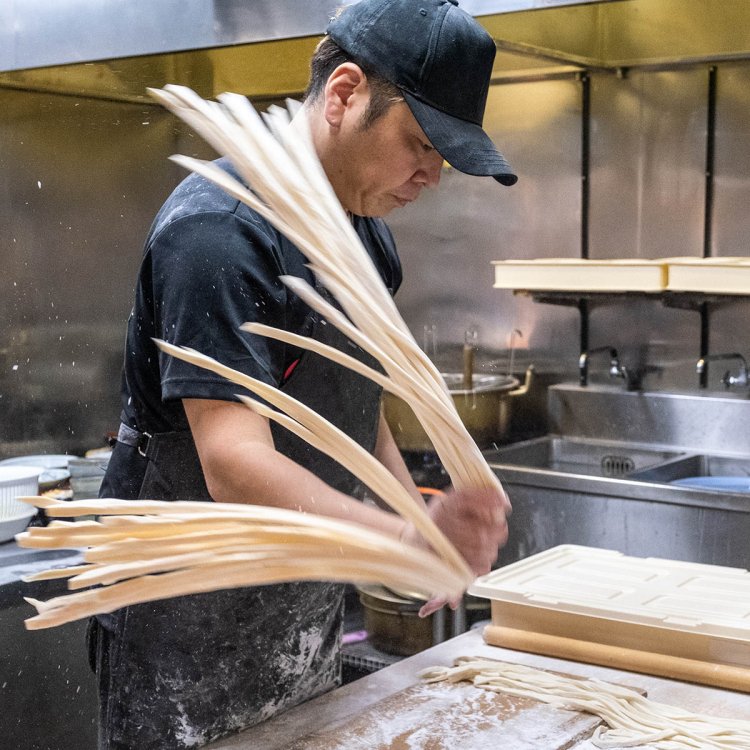 店内からも作業の様子がよく見える厨房で、打ちたてのうどんを見事に操る荻窪さん。