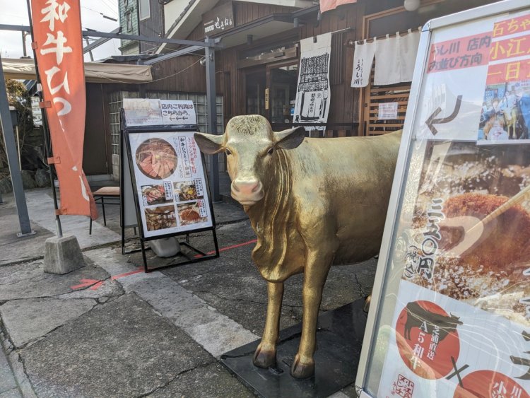 店先で人々を待っているのは、威厳たっぷり（？）の金色の牛。