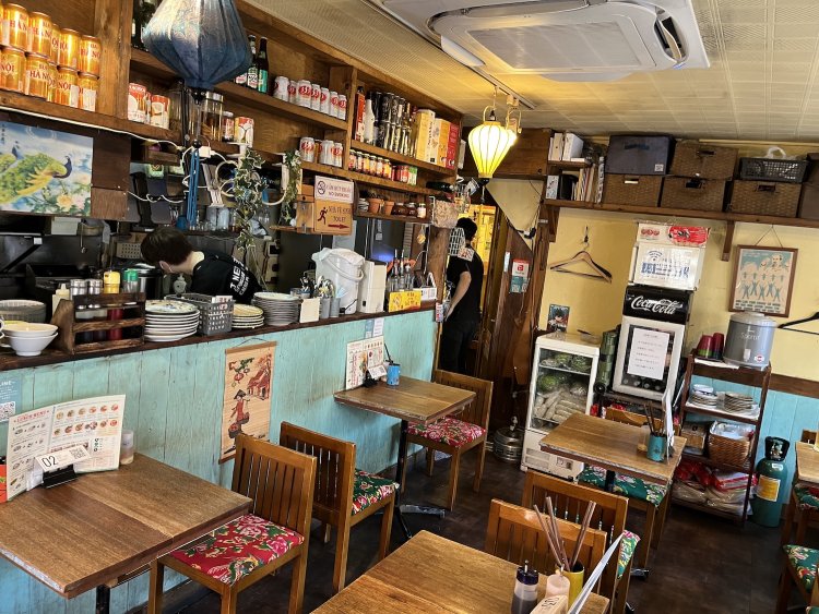 ミントグリーンの壁や、椅子の座面のベトナムらしいファブリックが目を引く。