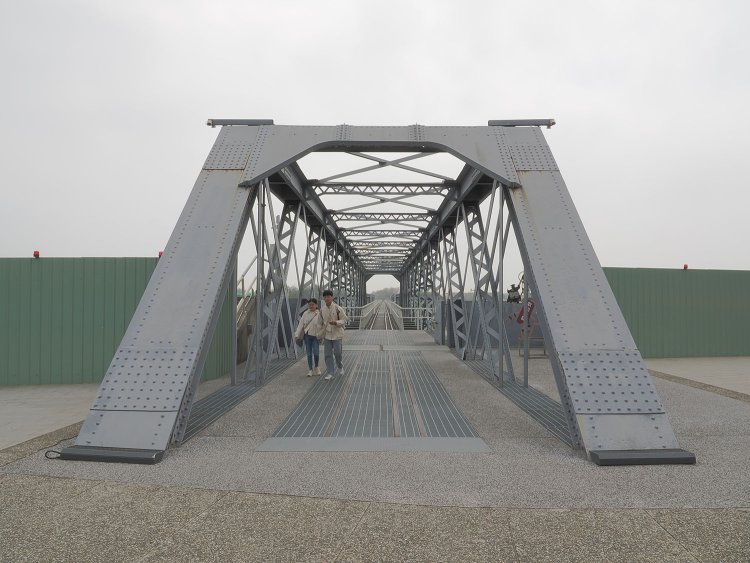 1番目のトラス橋。この先いくつもの種類の鉄橋を渡ることになる。トラス橋の顔となる端柱が太く重厚感溢（あふ）れるダブルワーレントラス。北海道の支笏湖に架かる山線鉄橋と似ている。