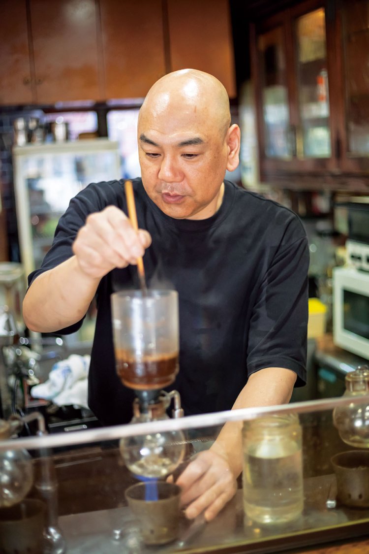2代目の沖野誠さん。注文を受けてからサイフォンでコーヒーを淹れる。