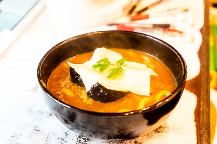 春夏限定の揚げなす&チーズ牛かれーうどんは1590円。