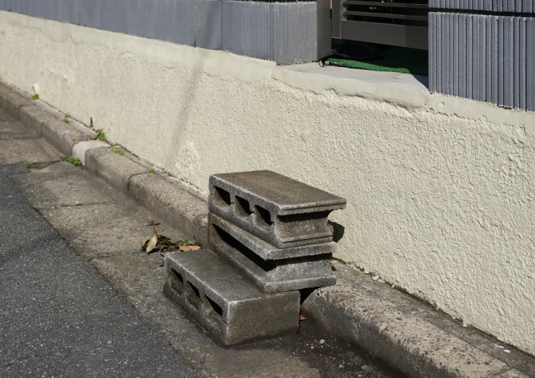 縁石の段差を生かしてコンクリートブロックを積み、出入り口につながる即席の階段を生み出す。