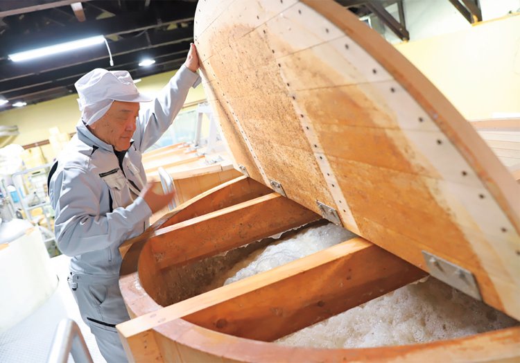 ウイスキーのもろみをチェックする代表の米澤仁雄さん。