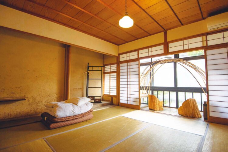目の前に湯出川を望む客室。トイレや洗面所、キッチンは共同。
