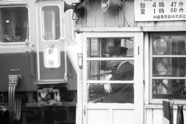 「開かずの踏切」は始発から終電まで警手が常駐。自動式の警報機と遮断機では不可能な開閉を実施して渡る人への利便性を確保していた時代もあった（1970年8月撮影）。