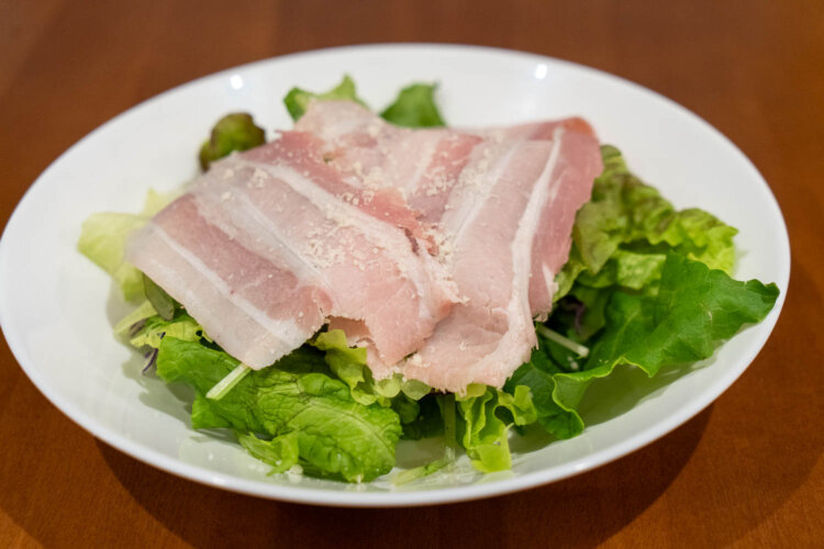 パスタを待つ間に出てくるサラダ。ハムは上品な味ながら旨味ぎっしり。