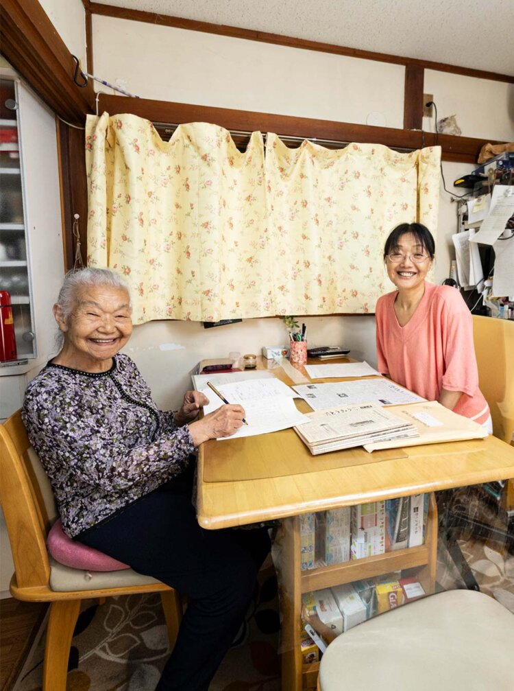 涌井友子さんと娘・久美子さん。居間のテーブルが仕事机だ。